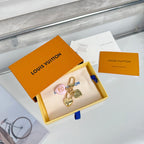 Heart keychain charm set in white pouch with Louis Vuitton box and papers