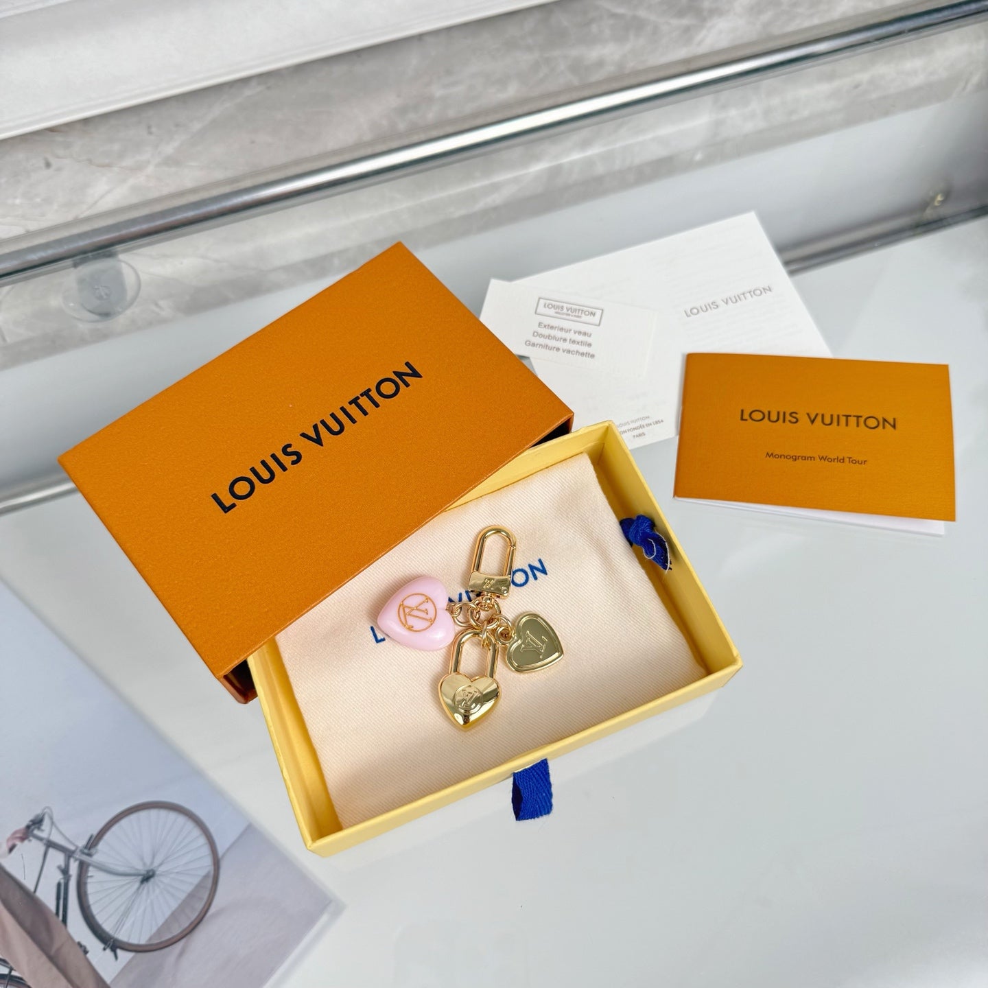 Heart keychain charm set in white pouch with Louis Vuitton box and papers