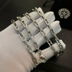 Silver chain bracelets on white gloves, multiple chains with lobster clasps