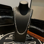 Silver chain necklace centered on mannequin with detailed link design