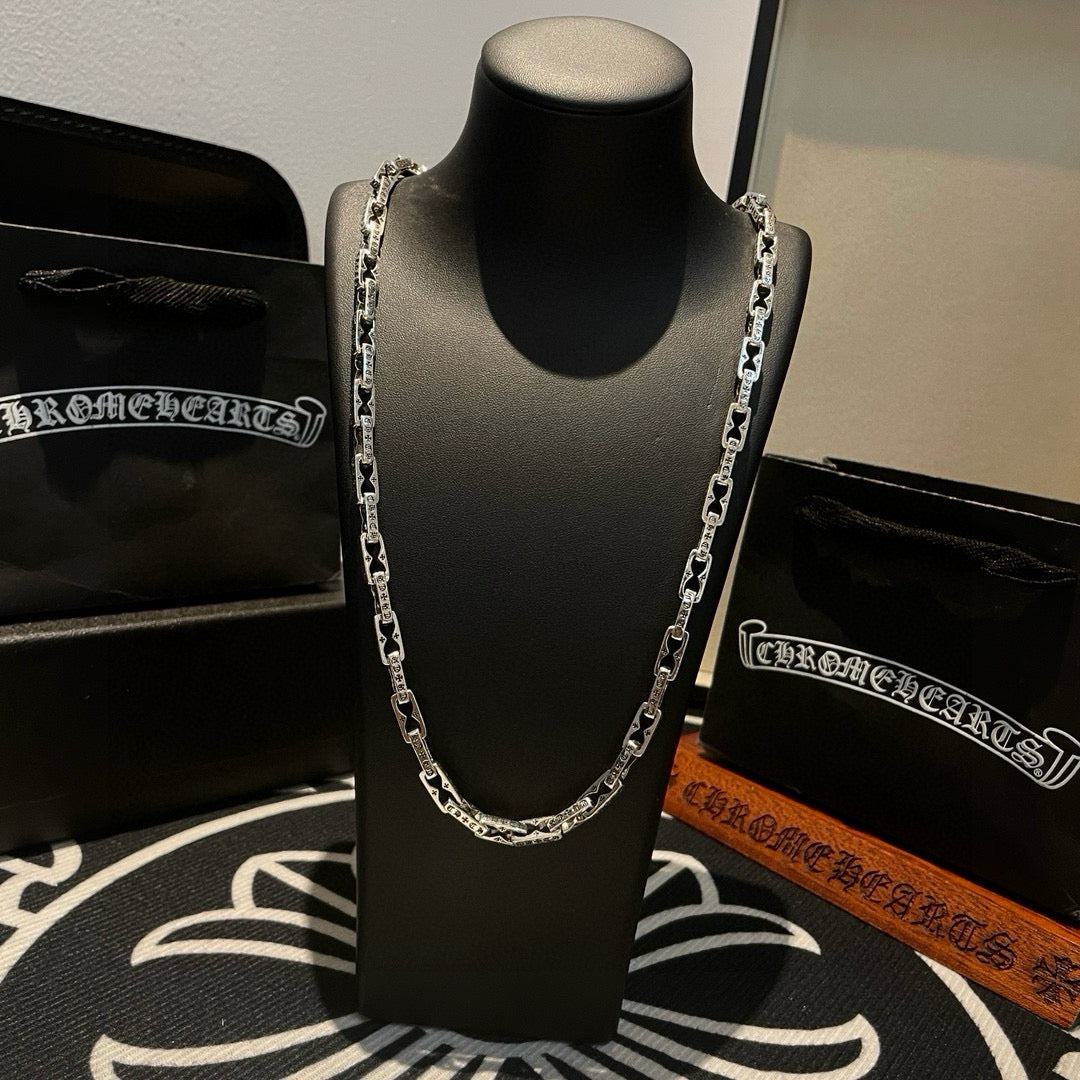 Silver chain necklace centered on mannequin with detailed link design