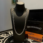Silver chain necklace on black display stand with clasp visible at neckline