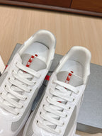 White lace-up sneakers with white laces and mesh tongue panel