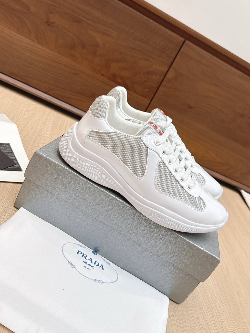 White low-top lace-up sneaker with gray side stripe and smooth sole