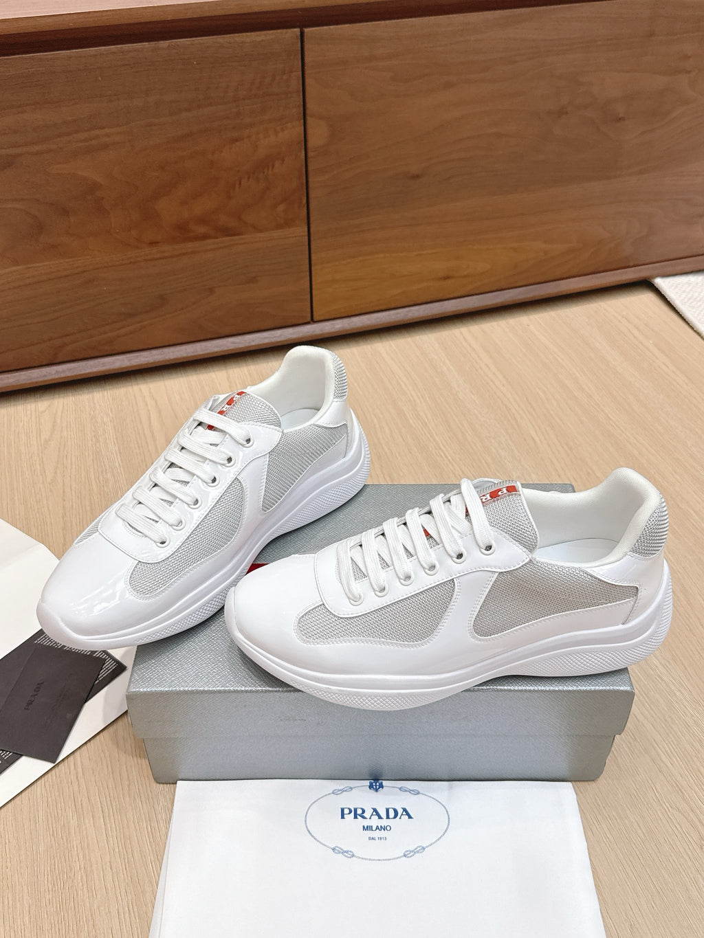 White low-top lace-up sneaker pair with mesh panels and padded collar