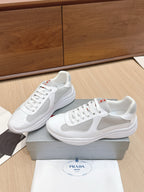White low-top lace-up sneaker pair with mesh panels and padded collar