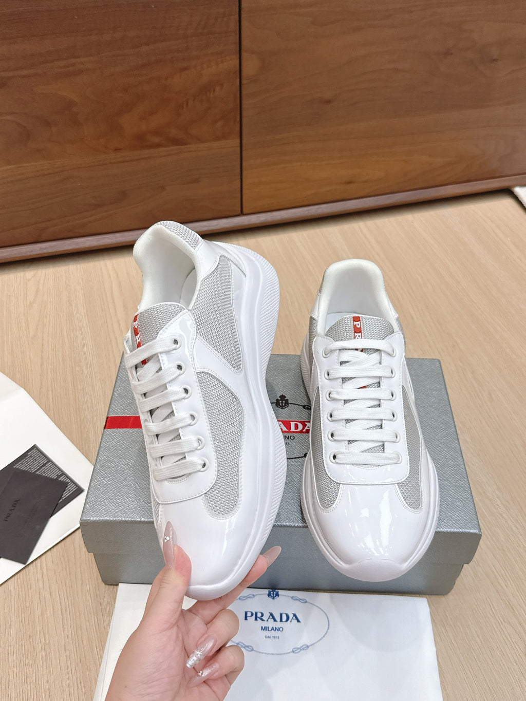 White lace-up sneaker with textured side panel and glossy trim