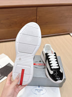 Prada unisex sneakers outsole view: white sole with patterned tread and heel label.