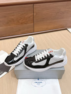 Prada unisex sneakers pair view: black and white uppers, white laces, white soles.