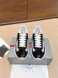 Prada unisex sneakers: black with white laces, white soles, black side stripe.