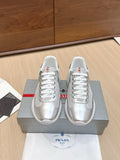 Unisex Prada sneakers in silver with white laces and red logo accents