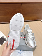 Prada unisex sneakers, outsole view with white tread and red heel patch