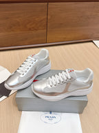 Unisex Prada sneakers with white/silver leather panels and lace-up design