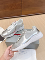 Unisex Prada sneakers with glossy silver finish and textured white outsole
