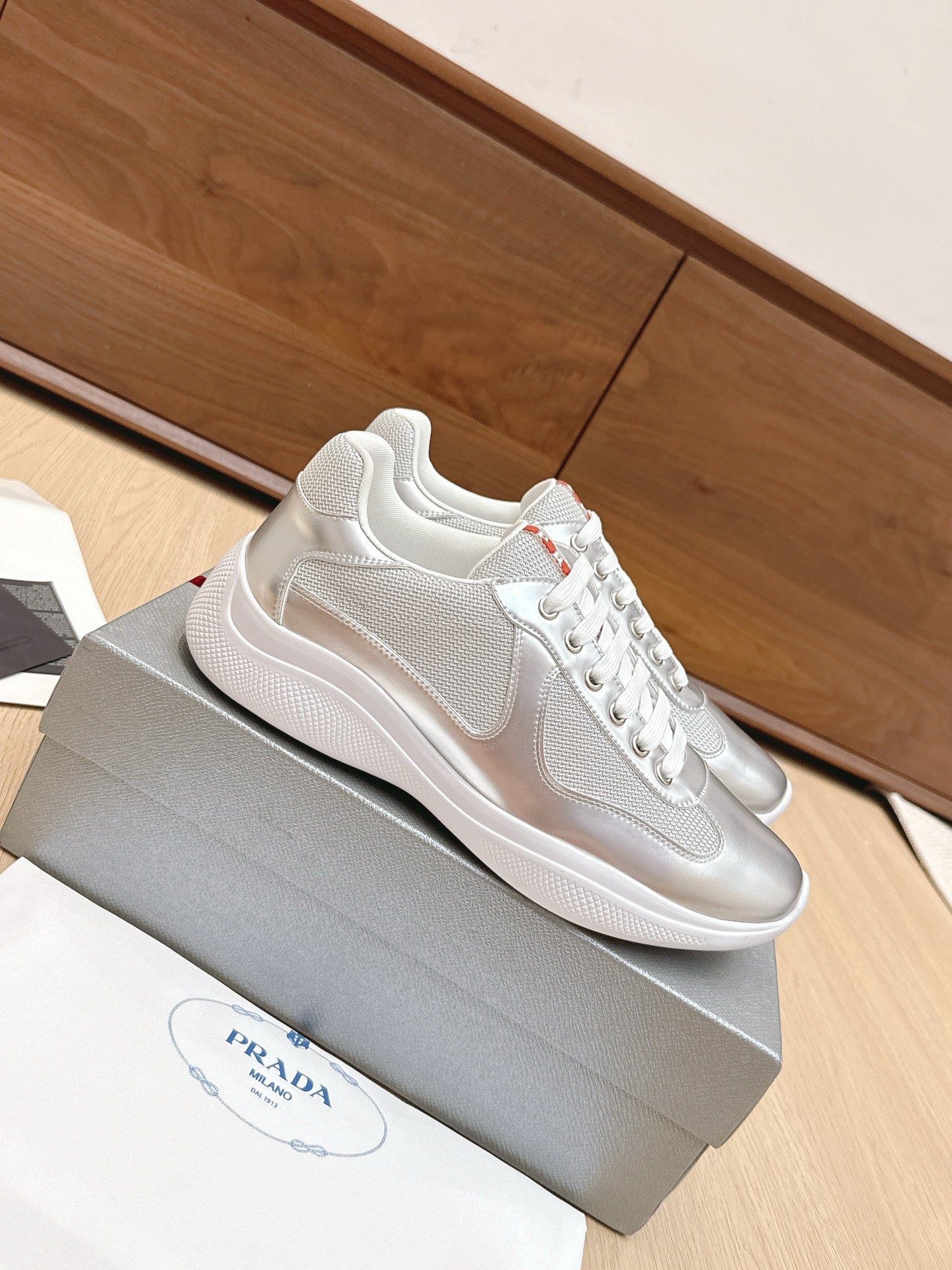 Unisex Prada sneakers, metallic silver uppers with white sole and lace-up
