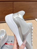 Prada unisex sneakers close-up, silver leather upper with thick white sole