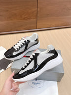 Prada unisex sneakers, two-tone black patent and gray mesh with white laces, side view