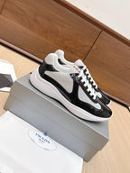 Prada unisex sneakers, side view: black patent leather with white laces and white sole