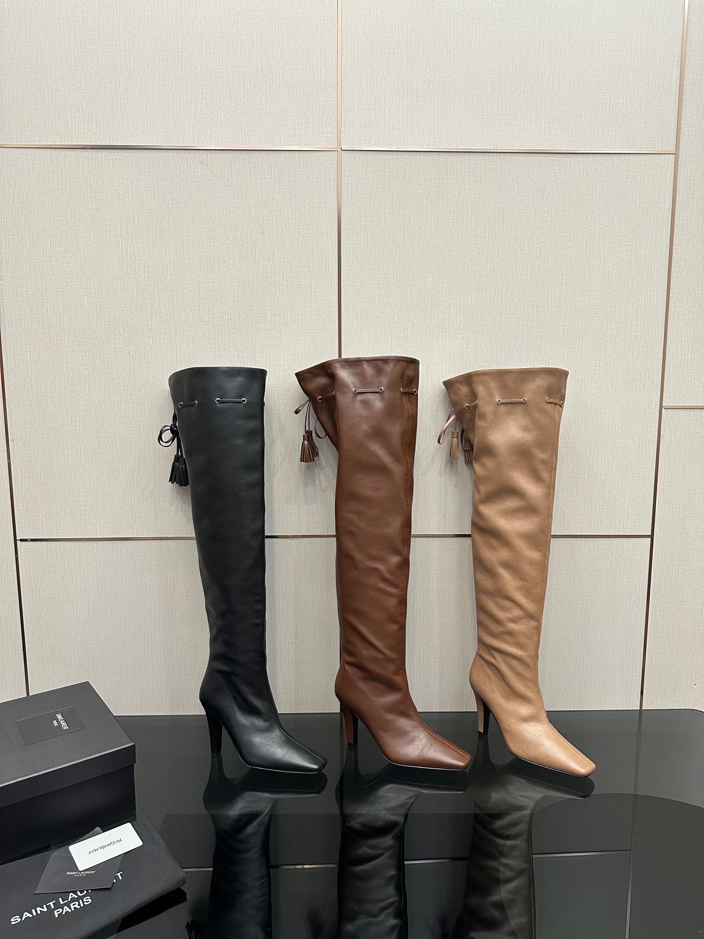 YSL assorted knee-high boots: black and brown pairs with stiletto heels