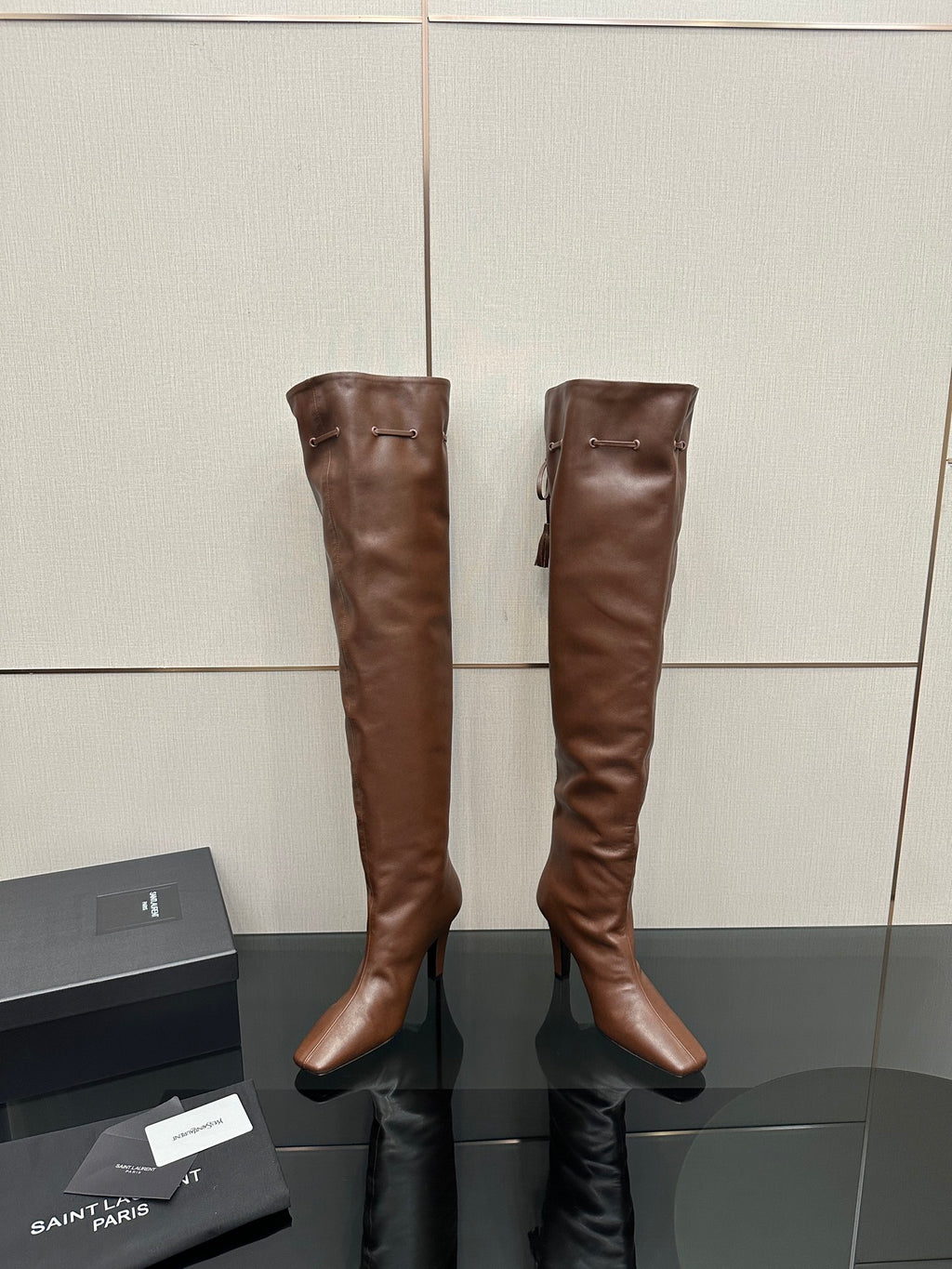 YSL knee-high leather boots, dark brown, back view with zipper pull and seams