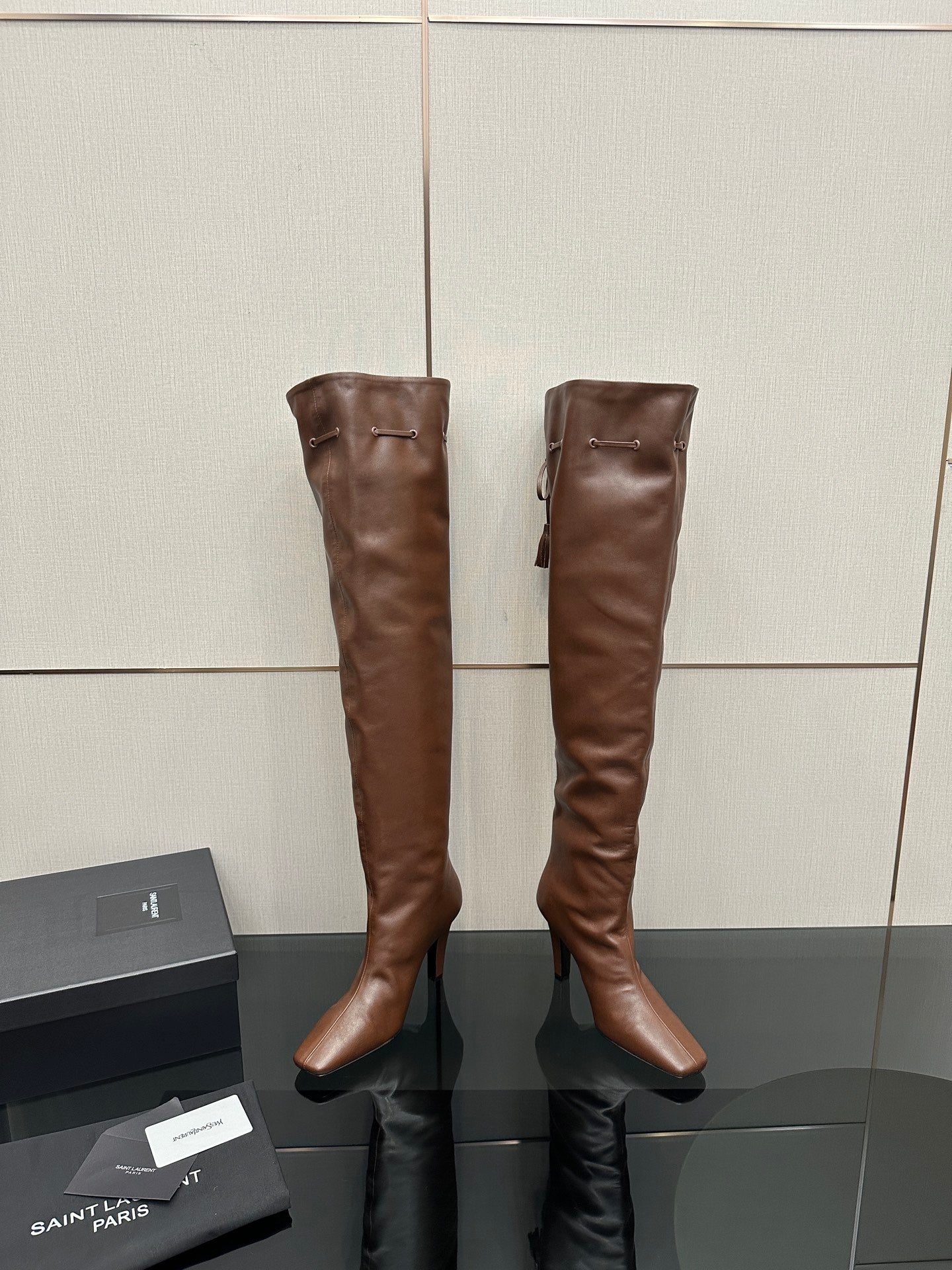 YSL knee-high leather boots, dark brown, back view with zipper pull and seams