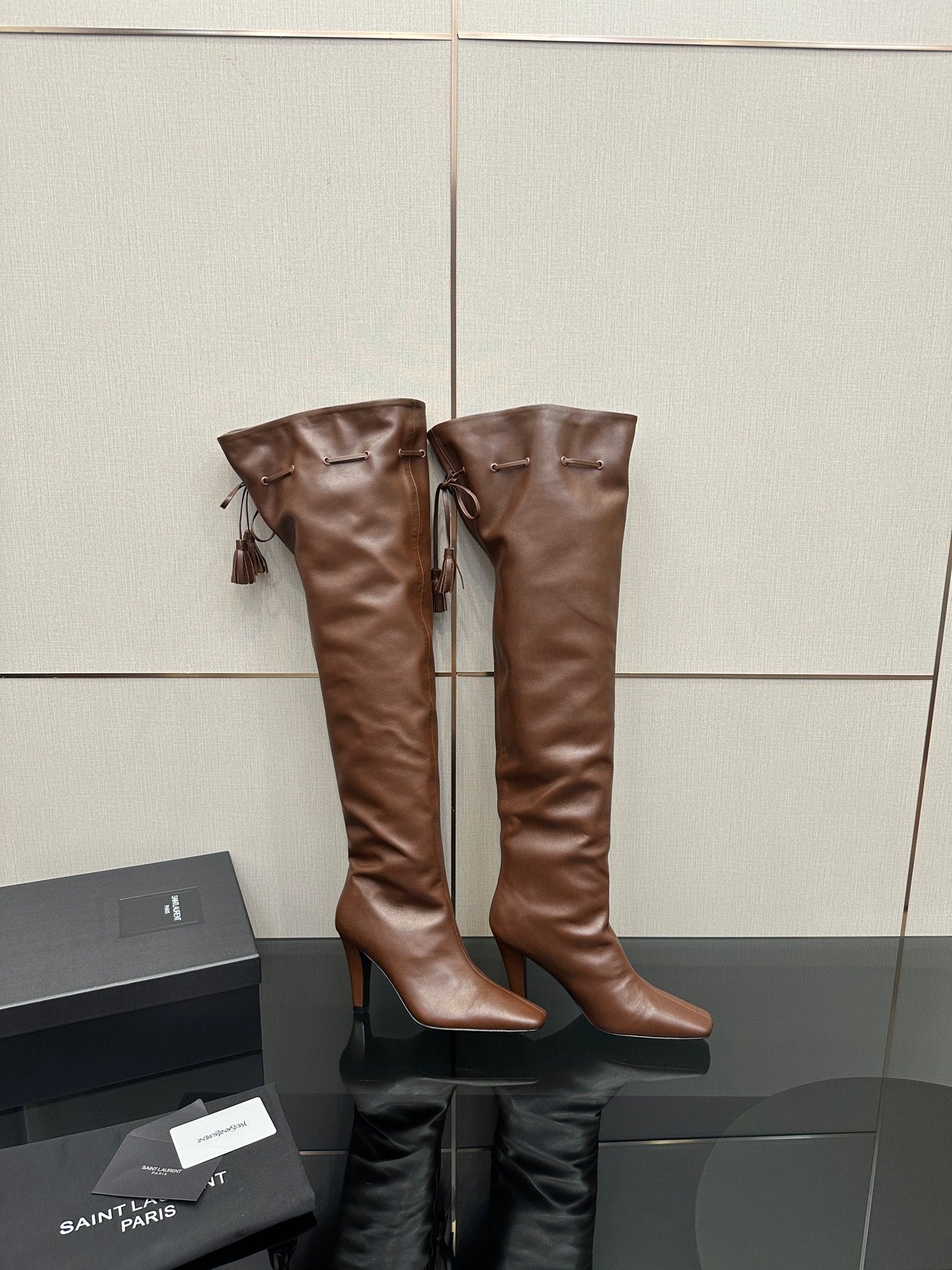 YSL ladies tall leather boots, dark brown, side view pair with tassels