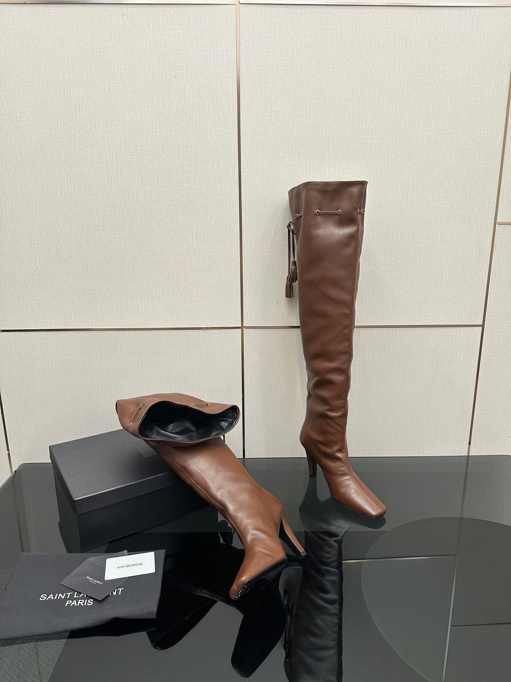 YSL tall leather boots, dark brown, angled side view with slim heel