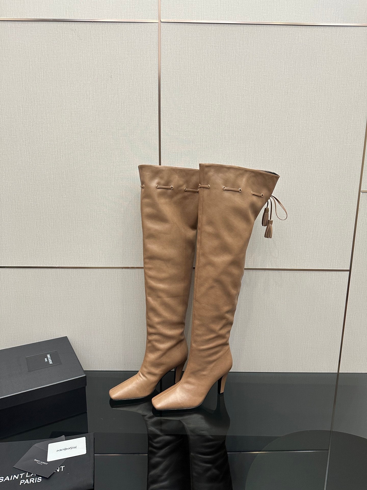YSL taupe knee-high leather boots with stiletto heel and tassel tie detail