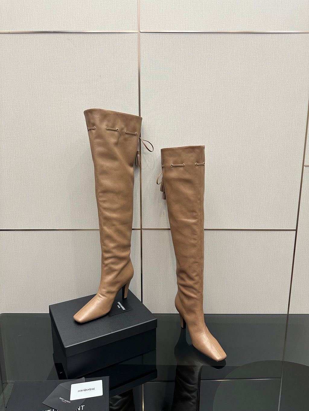 YSL taupe knee-high leather boots with stiletto heel and side tassel ties
