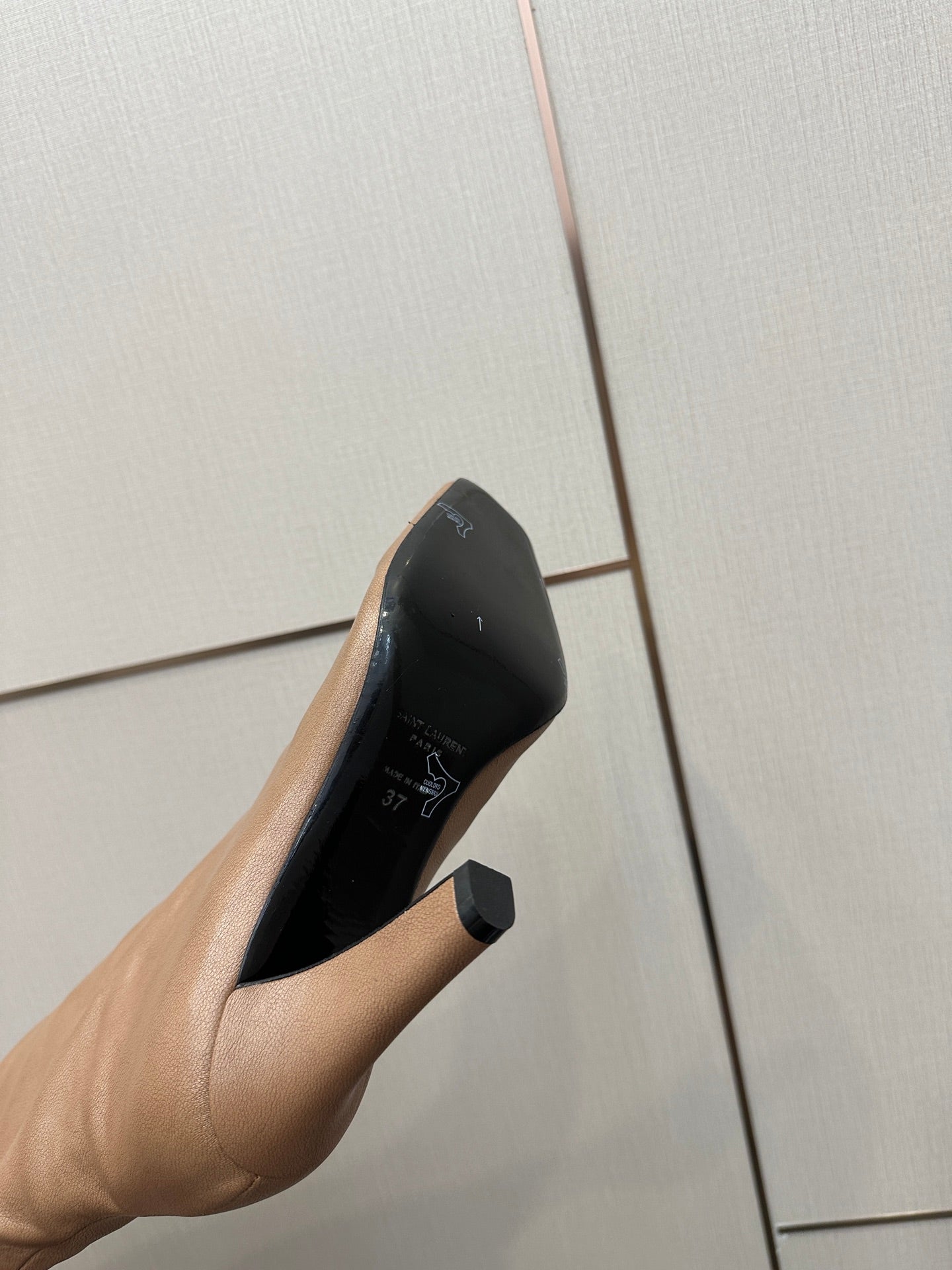 YSL taupe boot sole close-up with block stiletto heel and black interior