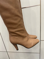 YSL taupe knee-high boot close-up with stiletto heel and smooth leather upper