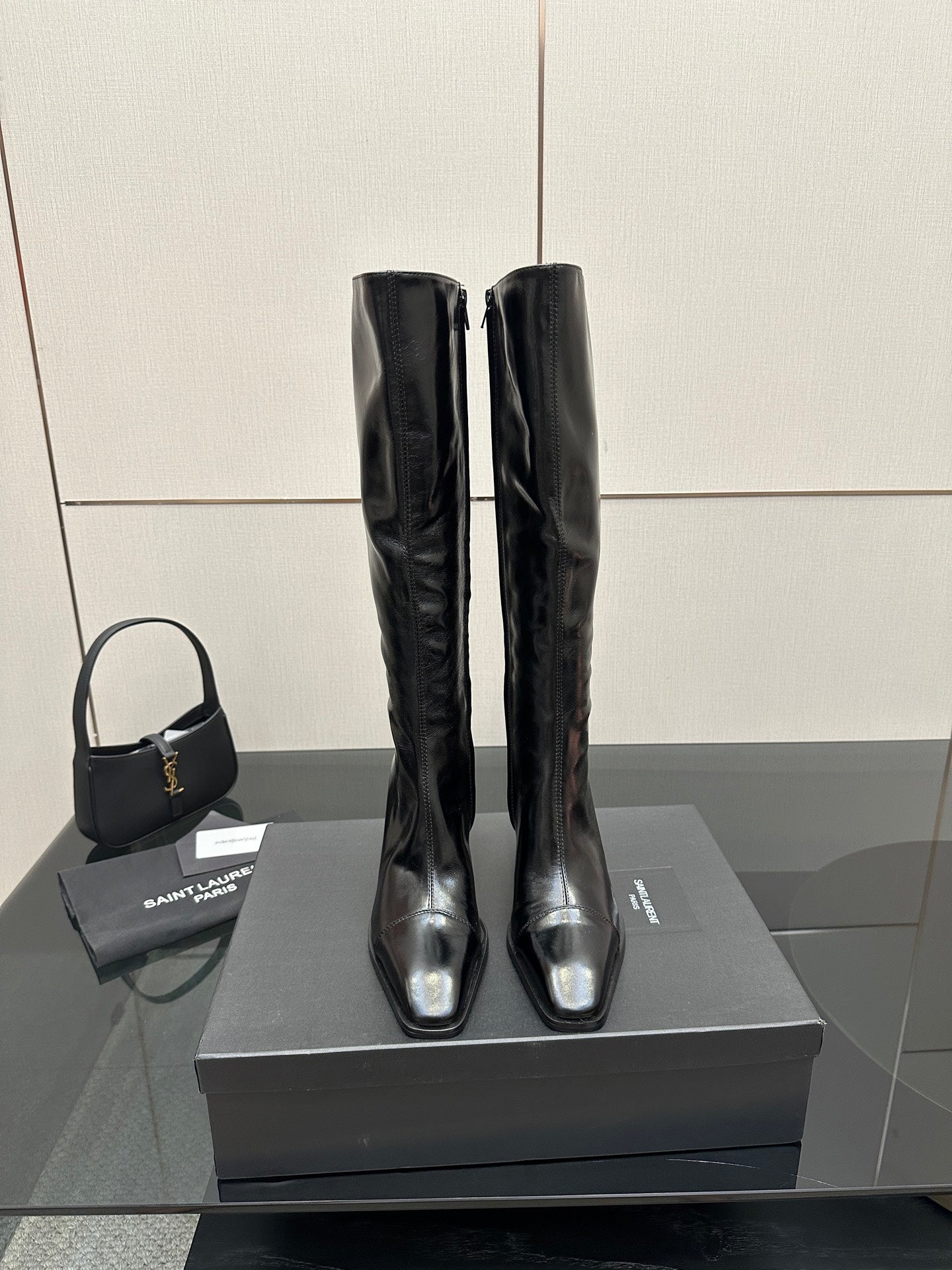 YSL ladies' tall boots, glossy black leather, slim heel, pull-on style.