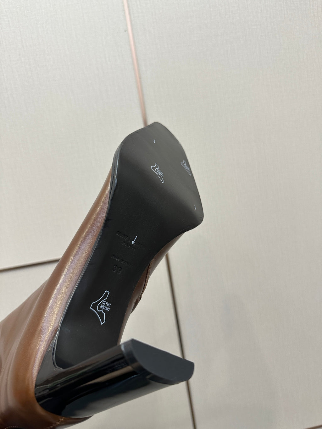 Brown leather boot sole and heel detail with logo print on inner lining