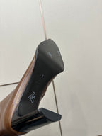 Brown leather boot sole and heel detail with logo print on inner lining