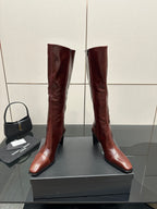 YSL ladies knee-high boots in dark burgundy glossy leather, front view with slim heel