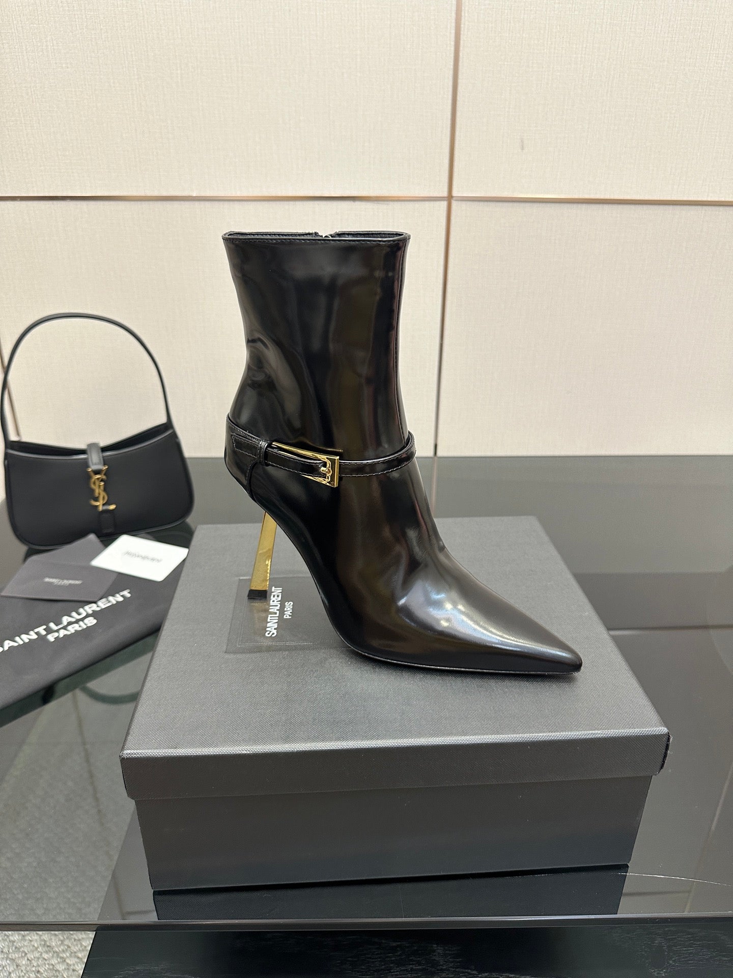 YSL ladies ankle boots, black glossy finish, gold buckle strap and stiletto heel