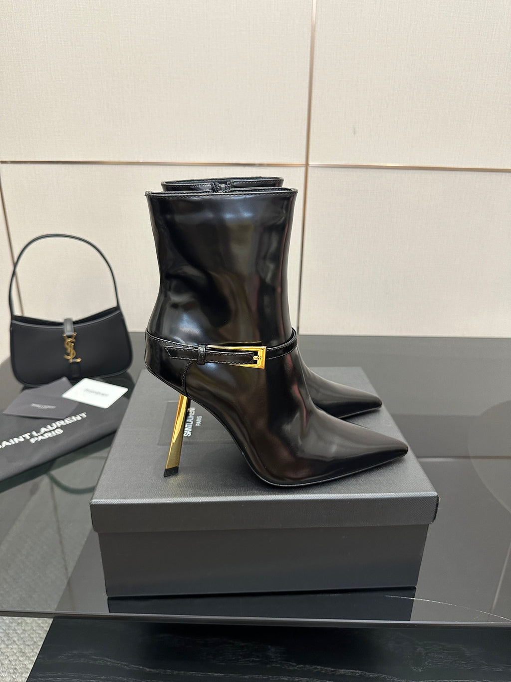 YSL ladies ankle boots with gold buckle, black patent look and tall stiletto heel