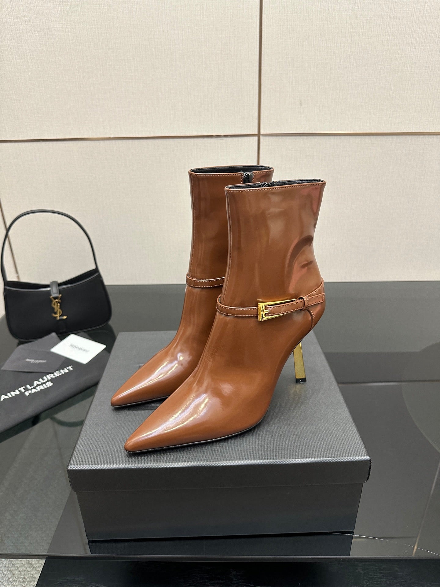 Women’s tan leather ankle boots with buckle strap, pointed toe, stiletto heel