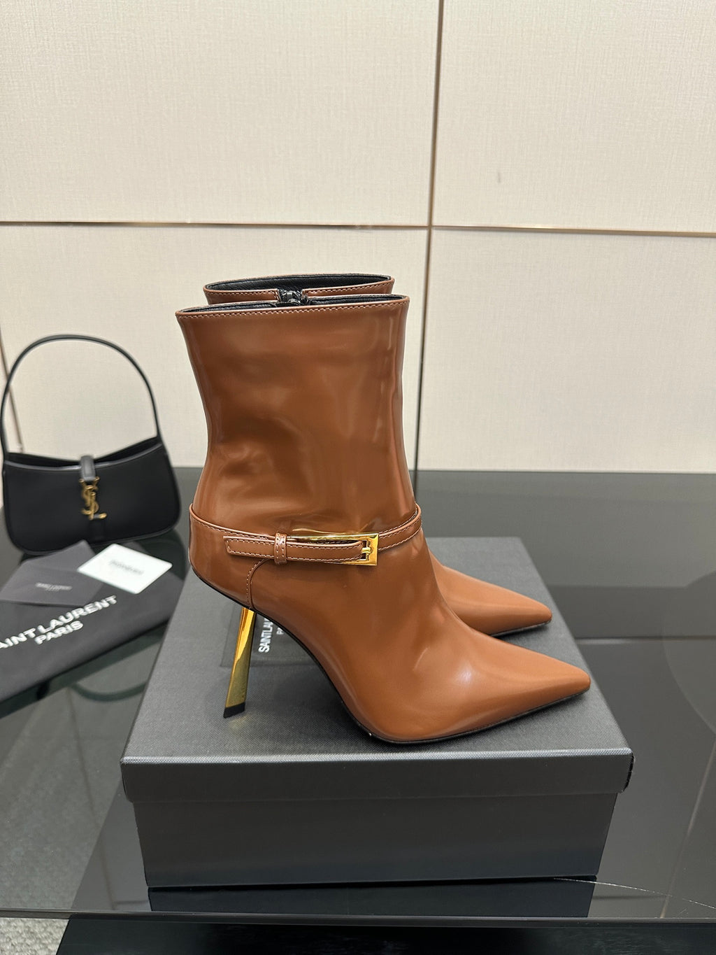 Women’s tan leather ankle boots, side zipper and gold buckle strap, stiletto heel