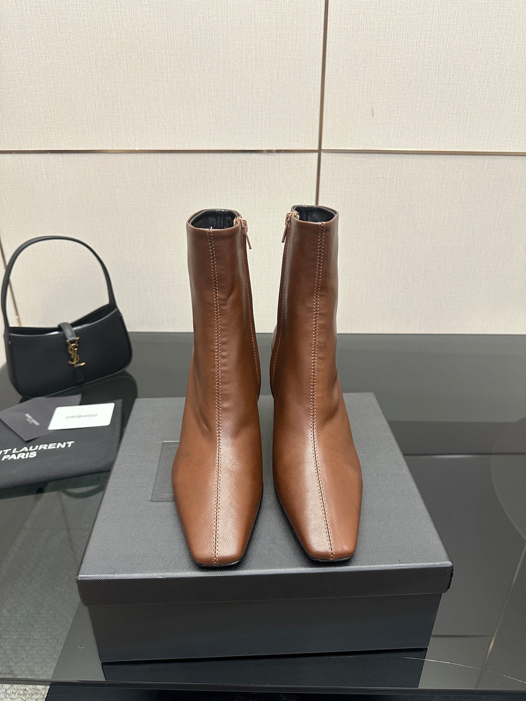 Women’s tan leather ankle boots with pointed toe and slim heels, side view pair