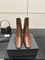 Women’s tan leather ankle boots with pointed toe and slim heels, side view pair