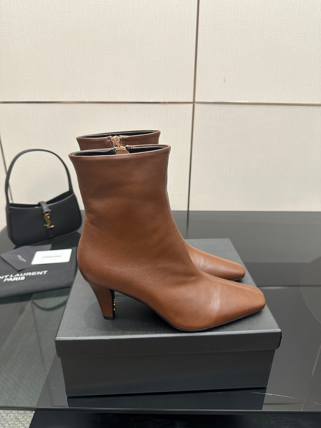 Women’s tan leather ankle boot on a box, pointed toe and slim block heel
