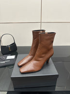 Women’s tan leather ankle boot, side view with pointed toe and slim heel