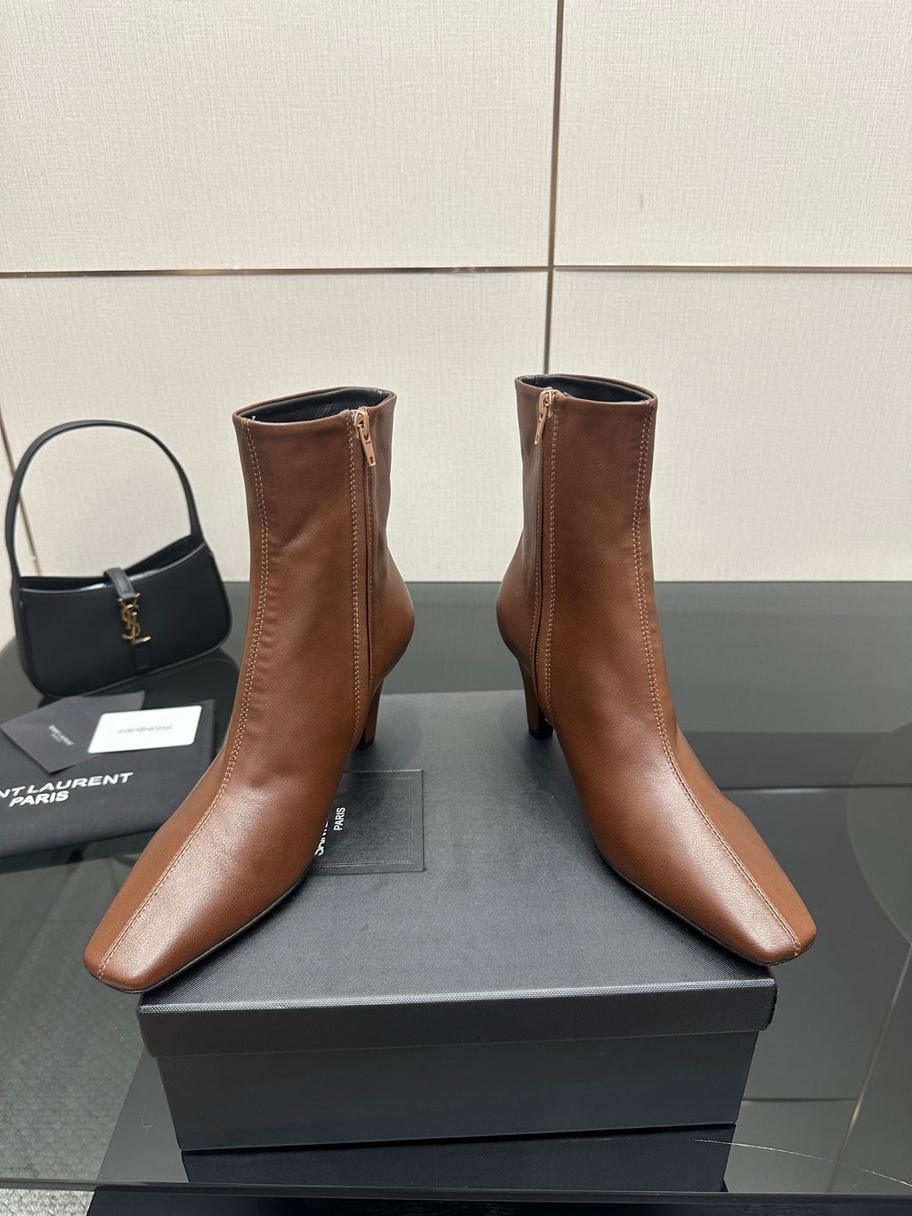 Women’s tan leather ankle boots with zip closure, pointed toe and slim heels
