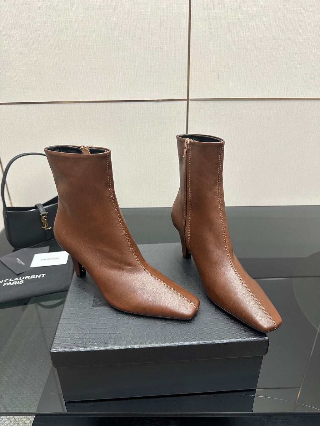 Women’s tan leather ankle boots with pointed toes and slim heels, angled pair view