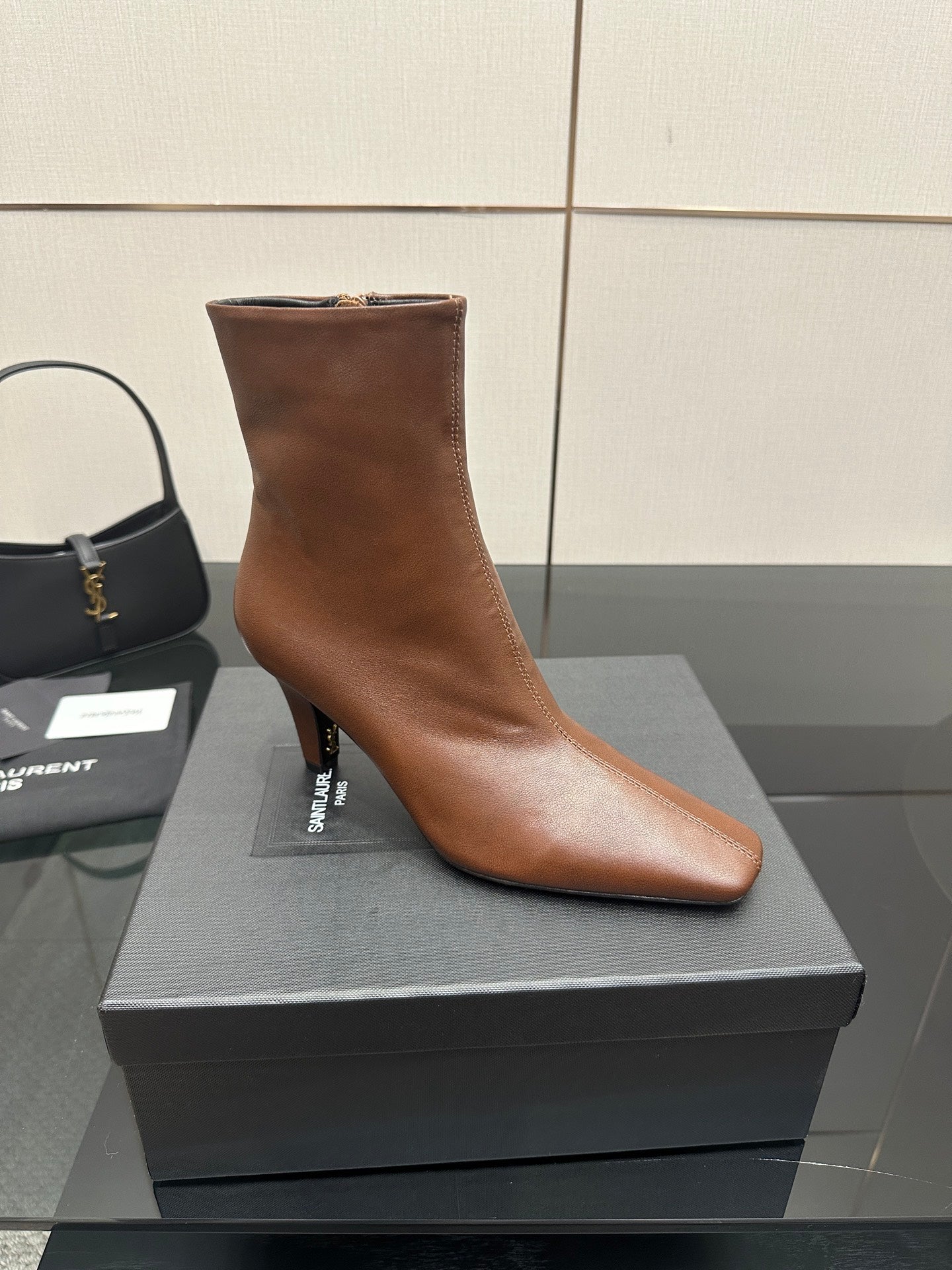 Women’s tan leather ankle boot, front angled view with pointed toe and slim heel