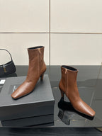 Women’s tan leather ankle boots with side zips, pointed toe and slim heels