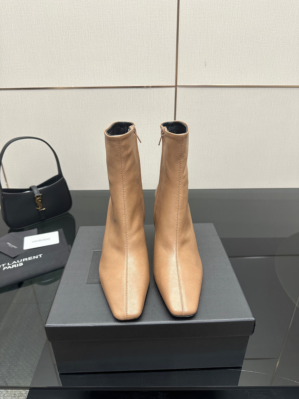 Beige ankle boots with pointed toe and slim high heel, pair on black box