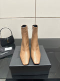 Beige ankle boots with pointed toe and slim high heel, pair on black box
