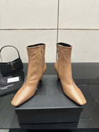 Beige ankle boots with pointed toe, slim high heel, zipper detail on box